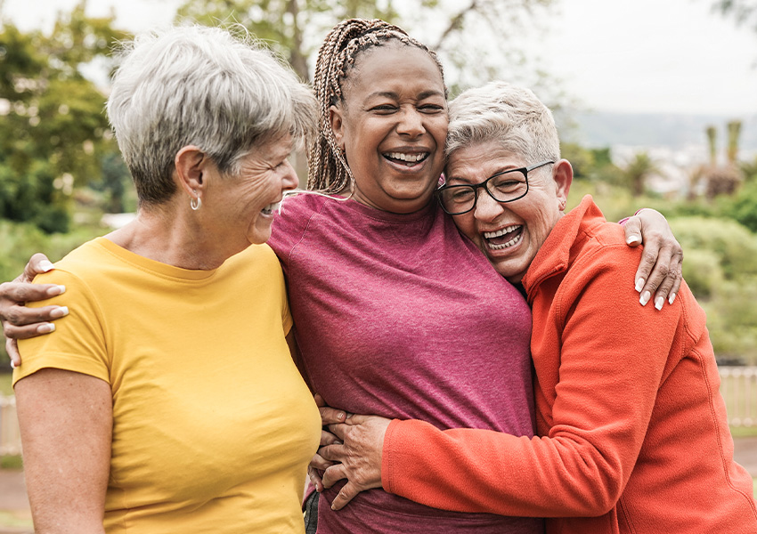 3 women in a friendly embrace