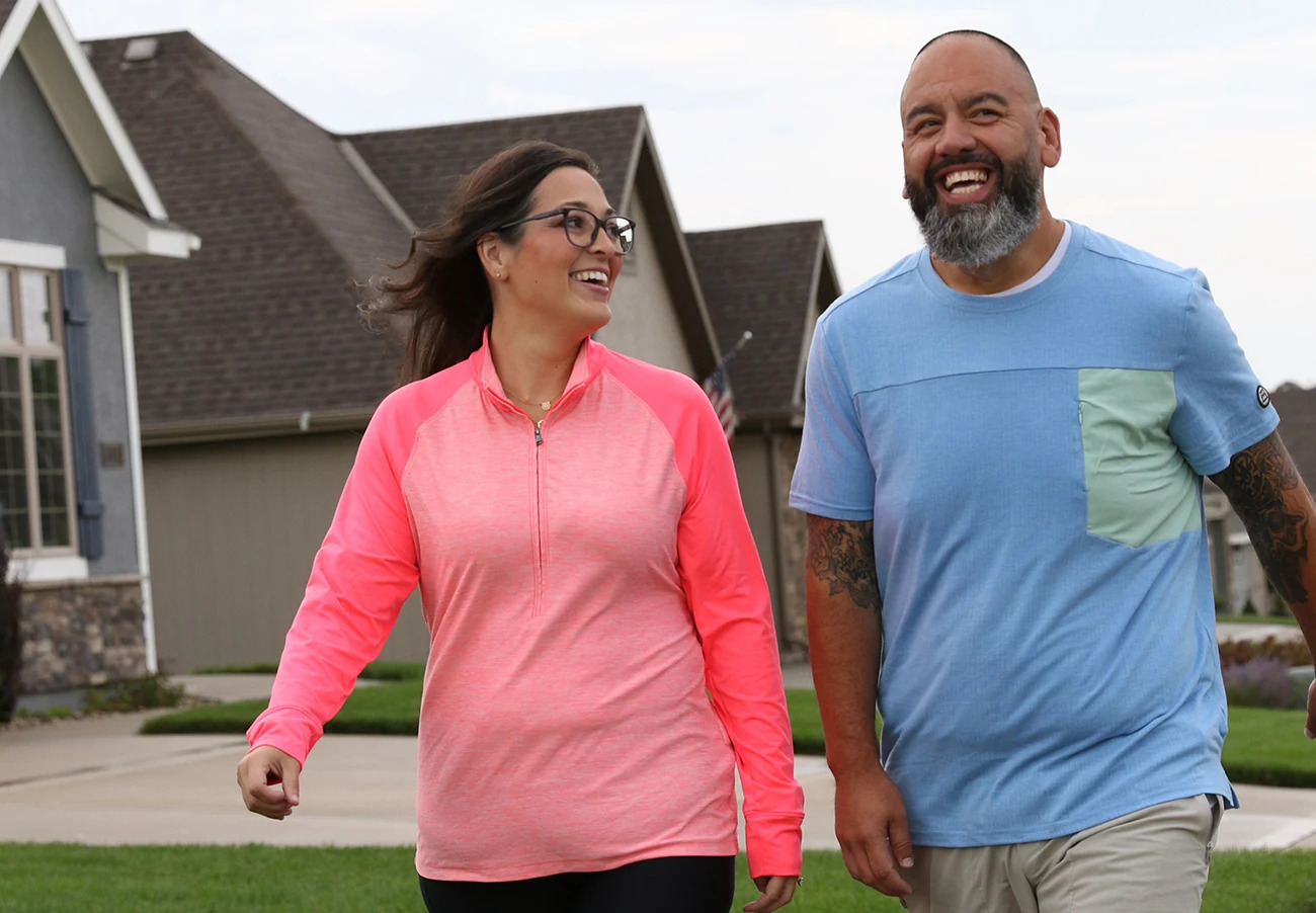 A woman on a walk with her husband down the block