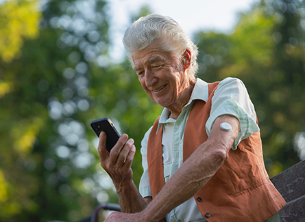 Senior man with continuous glucose monitor