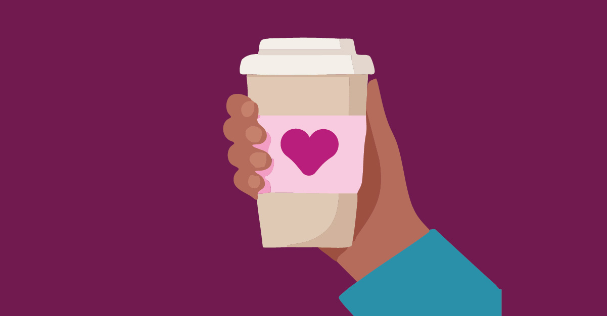Hand holding cup of coffee