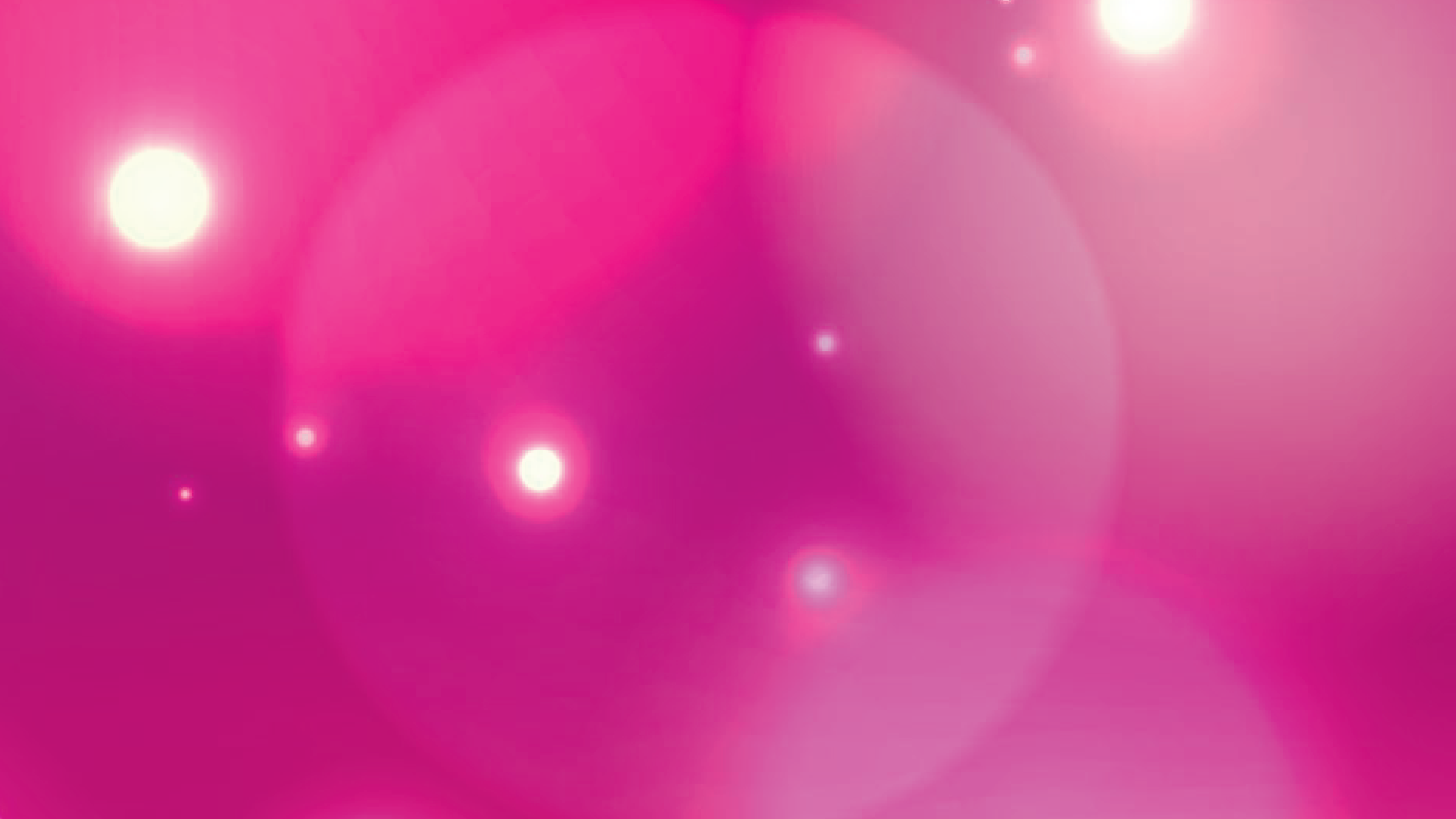 A swatch of pink with white lens flares littered about