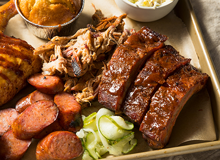 Platter of bbq with ribs, pulled pork and sausage