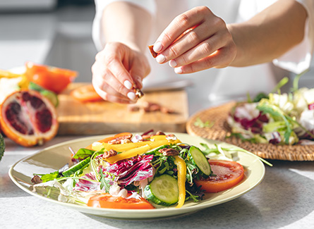 Close up of woman preparing healthy salad
