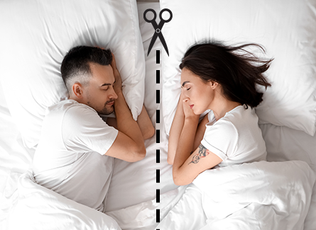 Couple in bed with scissors cutting between them. 