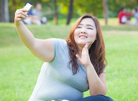 Woman in park taking selfie