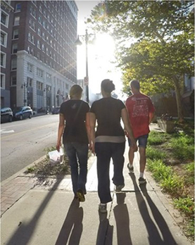Mary walking on sidewalk